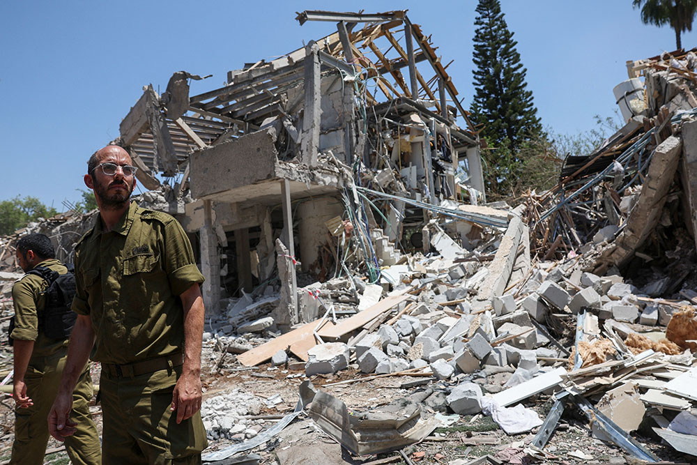 Members of Israeli forces work at an impact site following a missile attack from Iran on Israel, amid the Iran-Israel conflict, in Tel Aviv, Israel, June 22, 2025. (OSV News/Reuters/Violeta Santos Moura)