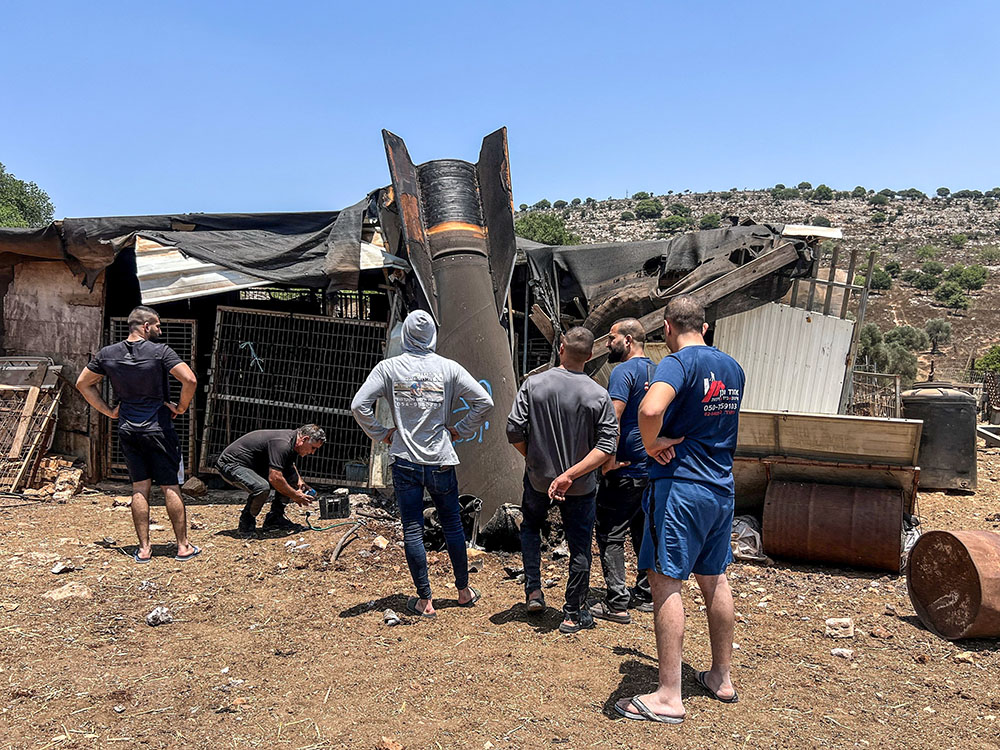 People look at the apparent remains of a ballistic missile following a missile attack by Iran on Israel, in northern Israel, June 24, 2025. (OSV News/Reuters/Avi Ohayon)