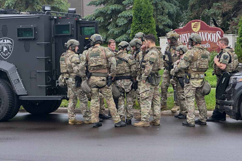 Police deploy as a manhunt is underway for a shooter that targeted two state lawmakers, in Brooklyn Park, Minn. on June 14.