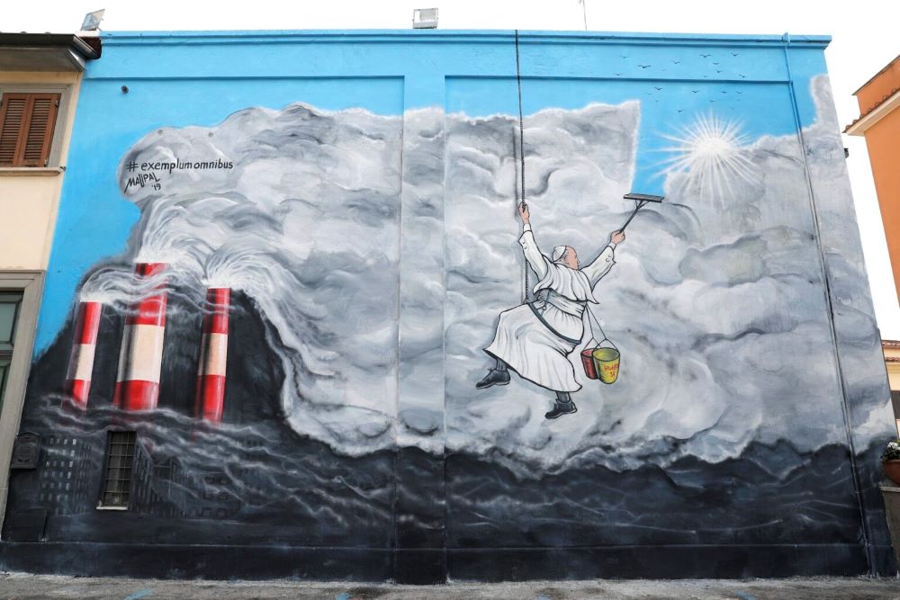 Pope Francis cleans the sky of pollution in graffiti by the artist Maupal, inspired by "Laudato Si'." (AP/Andrew Medichini) Pope Francis cleans the sky of pollution in graffiti by the artist Maupal, inspired by "Laudato Si'." (AP/Andrew Medichini)