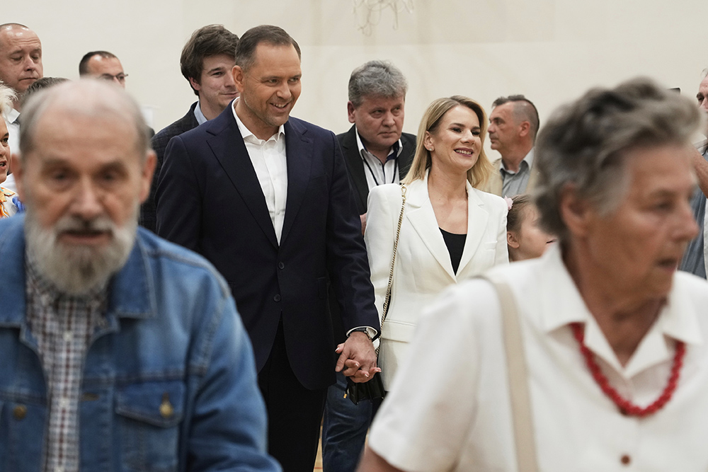 Presidential candidate Karol Nawrocki, center left, arrives at a polling station with his wife Marta Nawrocka, center right, during the presidential election runoff in Warsaw, Poland, June 1, 2025. (AP/Czarek Sokolowski)