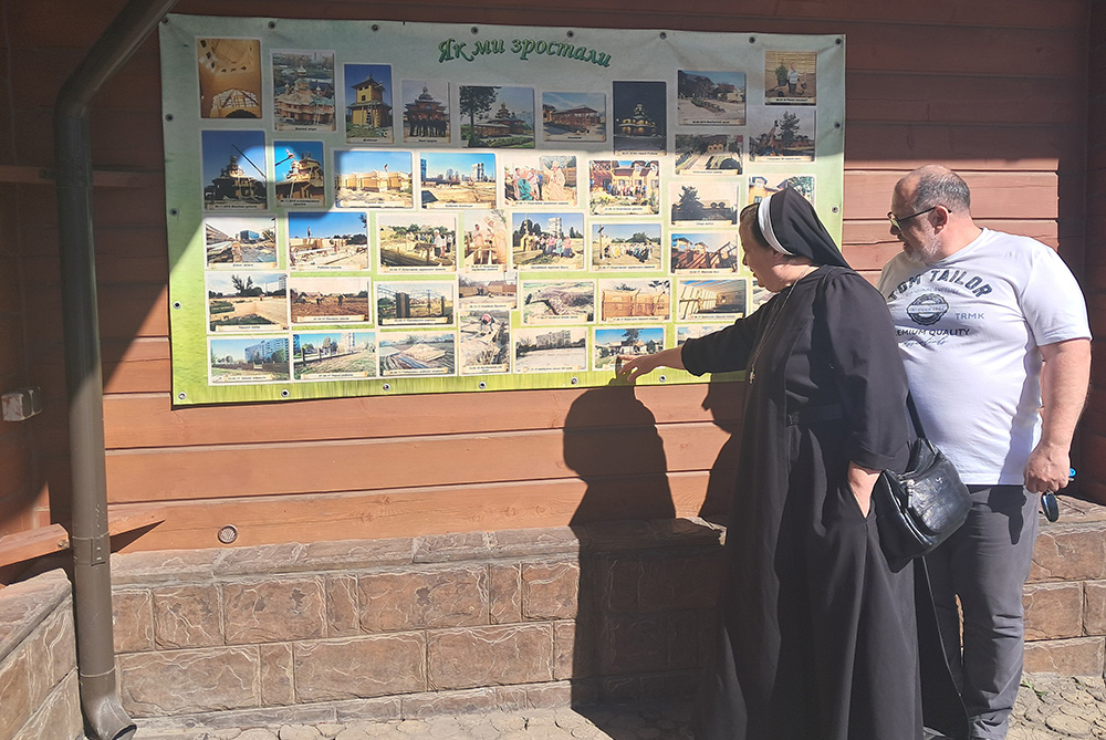 Sr. Lucia Murashko and Fr. Roman Vovk point to a photographic display about the history of Our Lady of Perpetual Help in Zaporizhzhia, a city in southern Ukraine. (Marc Roscoe Loustau)