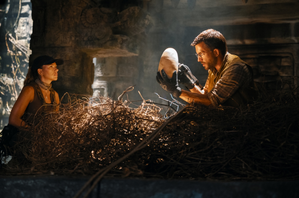 Scarlett Johansson looking at Jonathan Bailey holding an egg in "Jurassic World: Rebirth." (Universal Pictures) Scarlett Johansson looking at Jonathan Bailey holding an egg in "Jurassic World: Rebirth." (Universal Pictures)