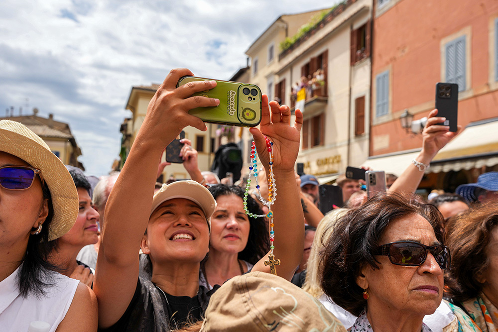 Visitors join Pope Leo XIV as he delivers his first Angelus from Castel Gandolfo, Italy, July 13, 2025. (CNS/Lola Gomez)