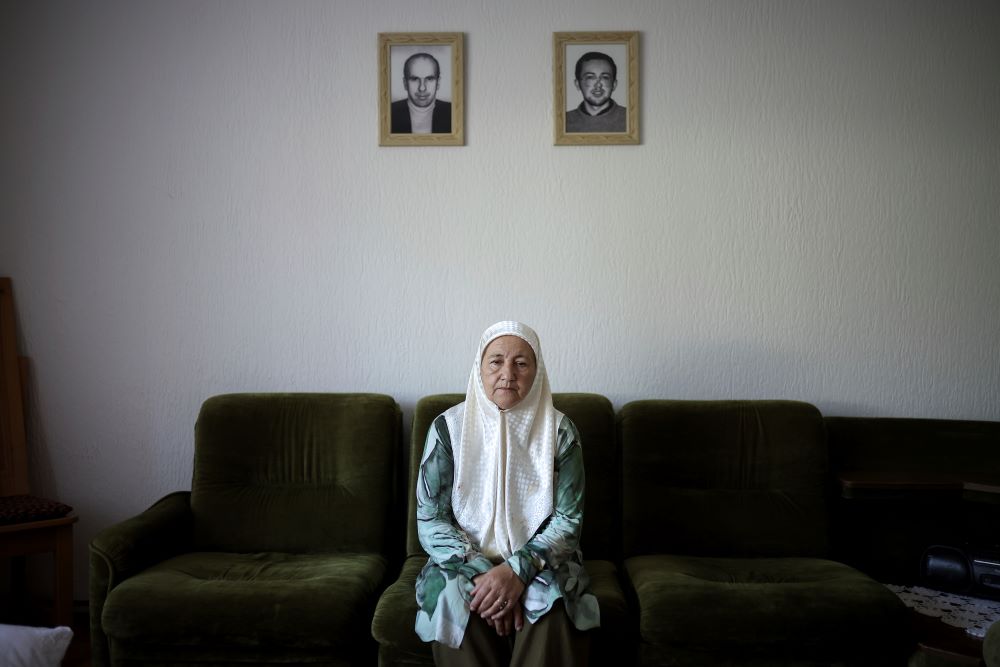 Fadila Efendic sits in her living room, with pictures of her son and husband on the wall behind her. Fadila Efendic sits in her living room, with pictures of her son and husband on the wall behind her. the village of Potocari near Srebrenica, Bosnia, on June 28. During the July 1995 genocide a total of 22 members of her family were killed. (AP/Armin Durgut)