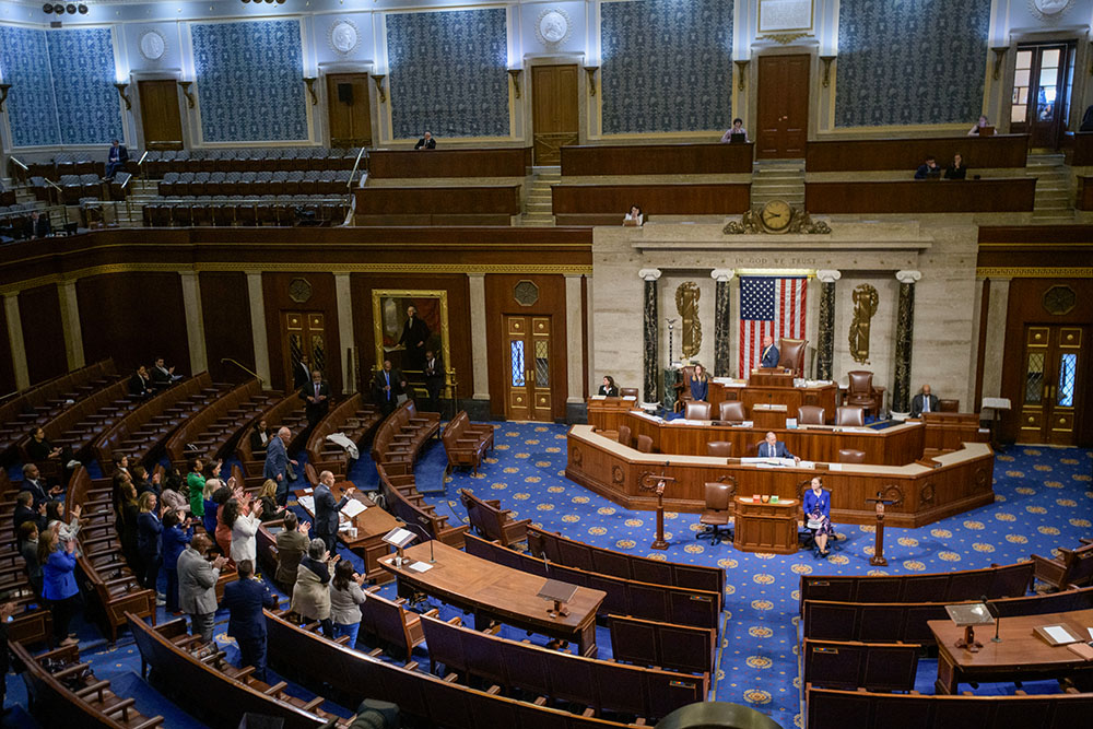 House Minority Leader Hakeem Jeffries, D-N.Y., left, speaks in the House chamber as House Democrats stand to applaud him, prior to the final vote for President Donald Trump's signature bill of tax breaks and spending cuts, at the Capitol, July 3, 2025, in Washington. (AP/Rod Lamkey Jr.)