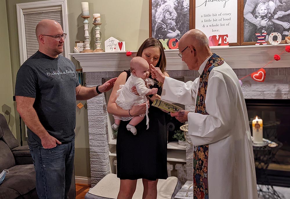 Phil Marcin is shown baptizing his grandson Declan, held by his mom, Maggie and alongside his dad, Phillip, in 2021. (Courtesy of Phil and Linda Marcin)