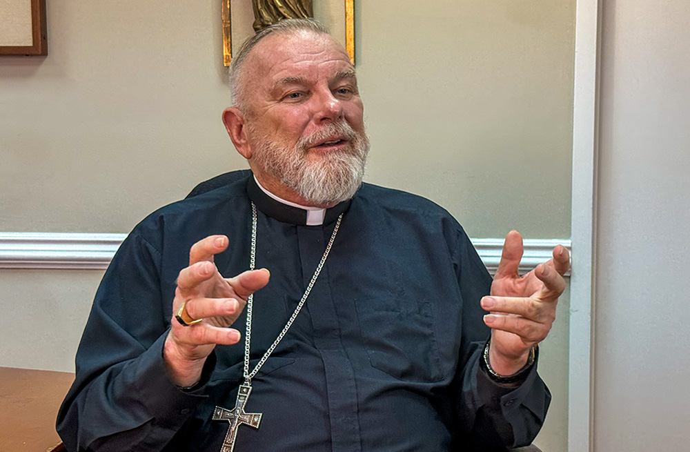 Miami Archbishop Thomas Wenski speaks with reporters July 21, 2025, at the pastoral center of the Miami Archdiocese in Miami Shores, Fla. (NCR photo/Garrett Shanley)