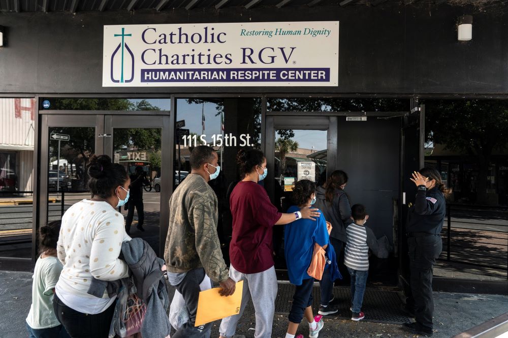 Migrants seeking asylum in the U.S. walk into a temporary humanitarian respite center run by Catholic Charities of the Rio Grande Valley in McAllen, Texas, April 8, 2021. Missouri's Catholic bishops in a statement called on U.S. lawmakers and policymakers to work toward merciful and just immigration policies for this country. (OSV News/Reuters/Go Nakamura)