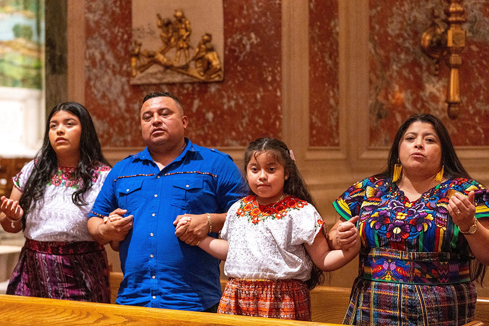 A family prays during Mass at the Cathedral of St. Matthew the Apostle in Washington Sept. 24, 2023. (OSV News/Catholic Standard/Mihoko Owada)