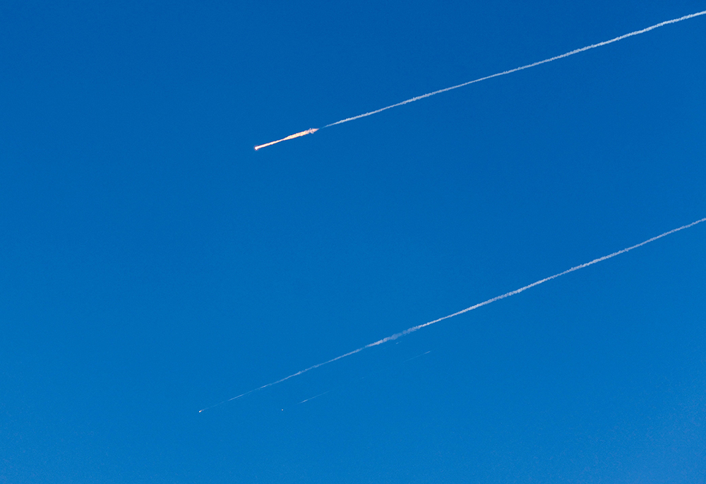 Iranian missiles fly toward Israel March 16, 2026, amid the U.S.-Israeli war with Iran, as seen from Hebron, in the Israeli-occupied West Bank. (OSV News/Reuters/Mussa Qawasma)