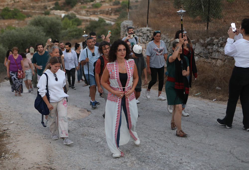 Amira Musallam walks during a nonviolent march led by women of multiple organizations to protest illegal settlers' annexation of Palestinian land in Beit Jala, West Bank, in August 2024. (Courtesy of Amira Musallam)