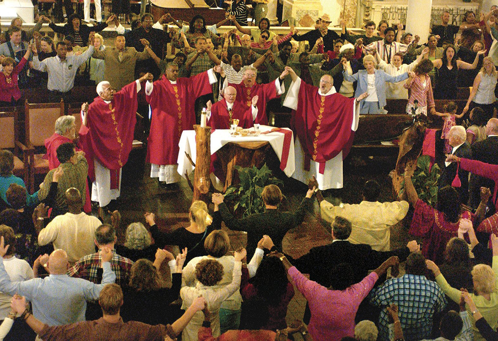 In this April 9, 2006, photo, then-New Orleans Archbishop Alfred C. Hughes, center, celebrates Palm Sunday Mass at St. Augustine Church, following a re-consecration ceremony April 8. Hughes, the main celebrant, was joined by former St. Augustine pastor Divine Word Fr. Jerome LeDoux, Deacons Jesse Watley and Ron Guidry, and Edmondite Fr. Michael Jacques, pastor of nearby St. Peter Claver Parish. (CNS/Clarion Herald/Frank J. Methe)