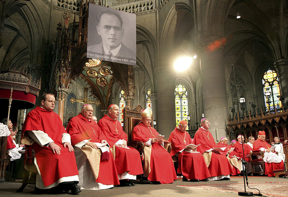 A portrait of Blessed Franz Jägerstätter hangs in St. Mary's Cathedral during his beatification in Linz, Austria, Oct. 26, 2007. Cardinal Jose Saraiva Martins, seated at far right, presided at the ceremony. (CNS/Reuters) 