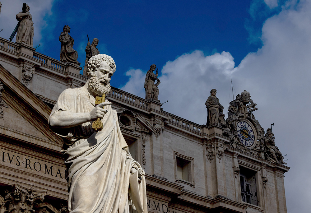 The sun lights up the statue of St. Peter in St. Peter's Square at the Vatican on a stormy Sept. 24, 2025, before Pope Leo XIV leads his weekly general audience. (CNS/Pablo Esparza)