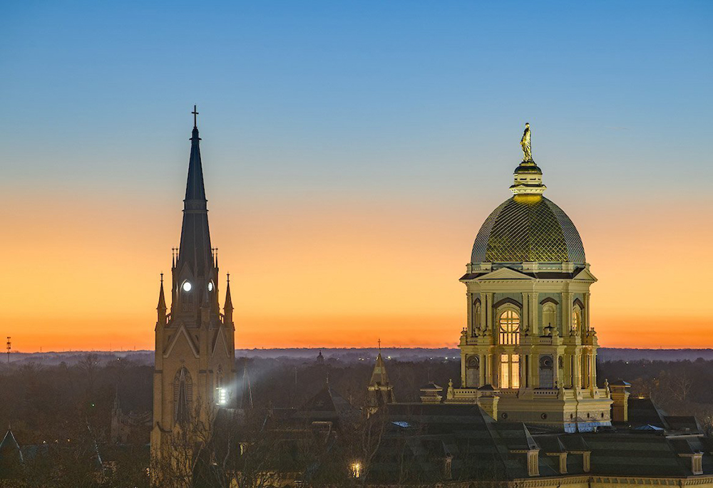 The sun sets over the main building and Basilica of the Sacred Heart steeple on the campus of the University of Notre Dame in South Bend, Indiana, Nov. 23, 2025. (OSV News/Courtesy University of Notre Dame/Matt Cashore)