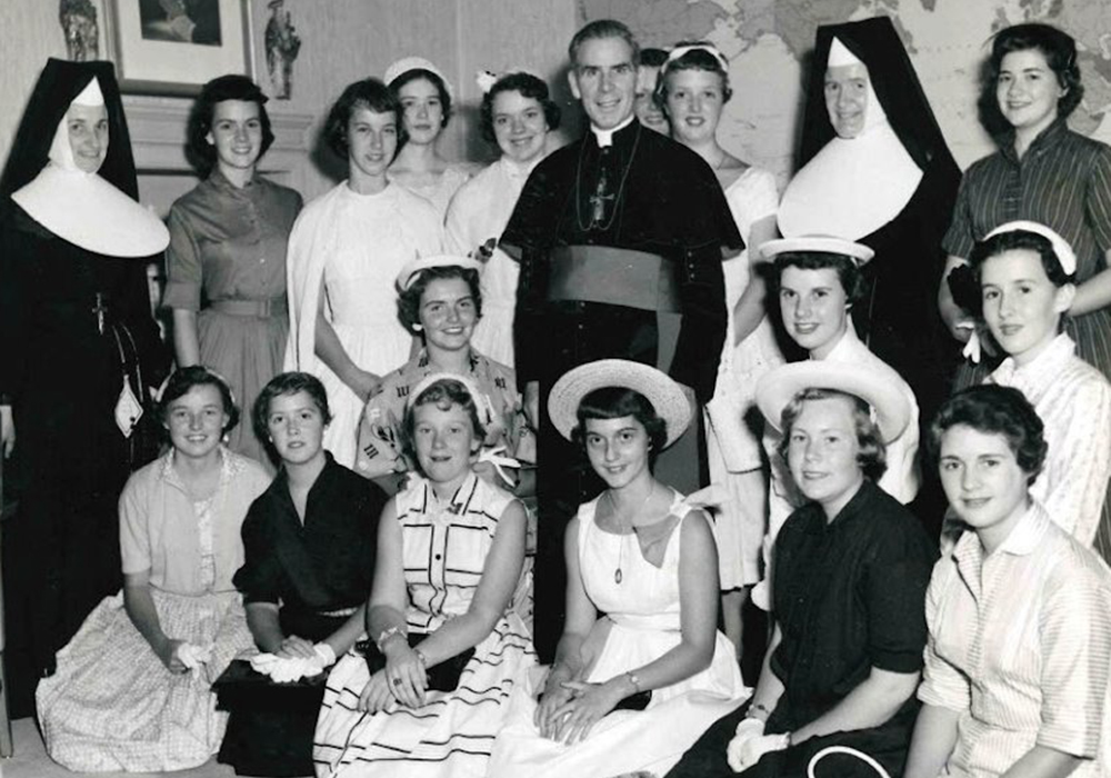 Archbishop Fulton J. Sheen is seen in an undated photo posing with women who worked at the Society for the Propagation of the Faith in New York City. (OSV News/Pontifical Mission Societies USA Archives)