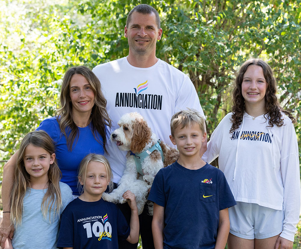 The Stommes family gathers for a photo in the front yard of their home in Minneapolis: front left, Esme, Etta and Finnegan; back left, Molly, Matt (holding Louie) and Charlize. The family lives across the street from Annunciation Church and School in Minneapolis. (OSV News/The Catholic Spirit/Dave Hrbacek)