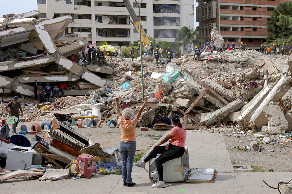 A woman prays as people work together to search for their loved ones amid debris in La Guaira, Venezuela, July 20, 2026, following the aftermath of the June 24 earthquakes. (OSV News/Reuters/Gaby Oraa)