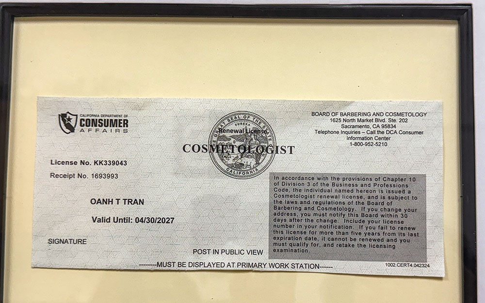 Daughter of Charity Sr. Oanh Tran displays her cosmetology license near her hair styling station at the Fr. Virgil Cordano Center in Santa Barbara, California. (GSR photo/Rhina Guidos)