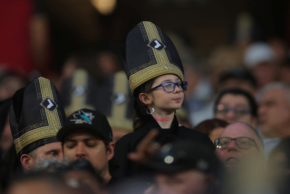 A fan wears a promotional pope hat during a baseball game between the Cincinnati Reds and Chicago White Sox, Aug. 11, 2026, in Chicago. Pope Leo's beloved White Sox lost to the Cincinnati Reds, 5-4. (AP/Melissa Tamez)
