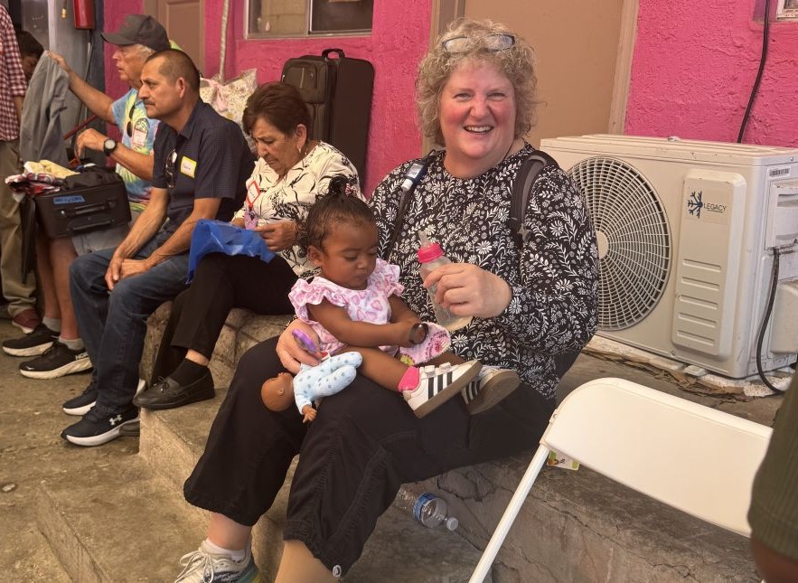Society of the Sacred Heart Sr. Lisa Buscher smiles at another sister after feeding a child at the Cobina Posada del Migrante shelter in Mexicali, Mexico, June 6, 2026. (GSR photo/Rhina Guidos)