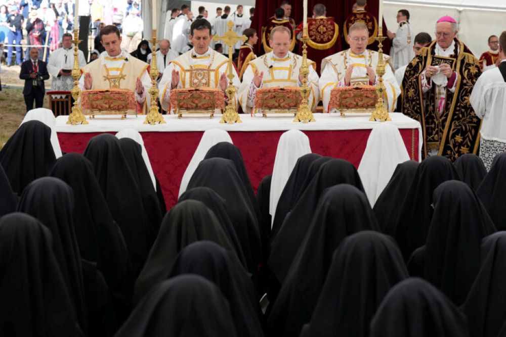 Marc Hanappier, from left, Michel Poinsinet de Sivry, Michael Goldade and Pascal Schreiber pray during their consecration ceremony as bishops in a tent set up outside the Society of St. Pius X seminary, in Econe, Switzerland, Wednesday, July 1, 2026. (RNS/AP/Baz Ratner)