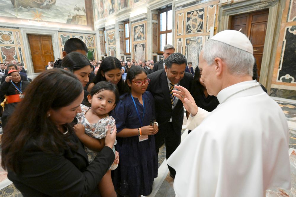 Pope Leo XIV blesses a child as he meets with participants of the XVII Annual Meeting of International Catholic Legislators Network at the Vatican Aug. 21, 2026. (OSV News/Vatican Media/Matteo Pernaselci) 