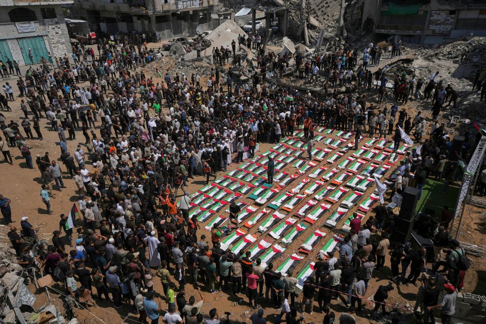 Bodies of members of the Hassayna and Abu Sharia families, killed in an Israeli strike in 2023 and recently recovered from the rubble, are draped in Palestinian flags during their funeral in Gaza City, Tuesday, Aug. 4, 2026. (AP/Jehad Alshrafi)