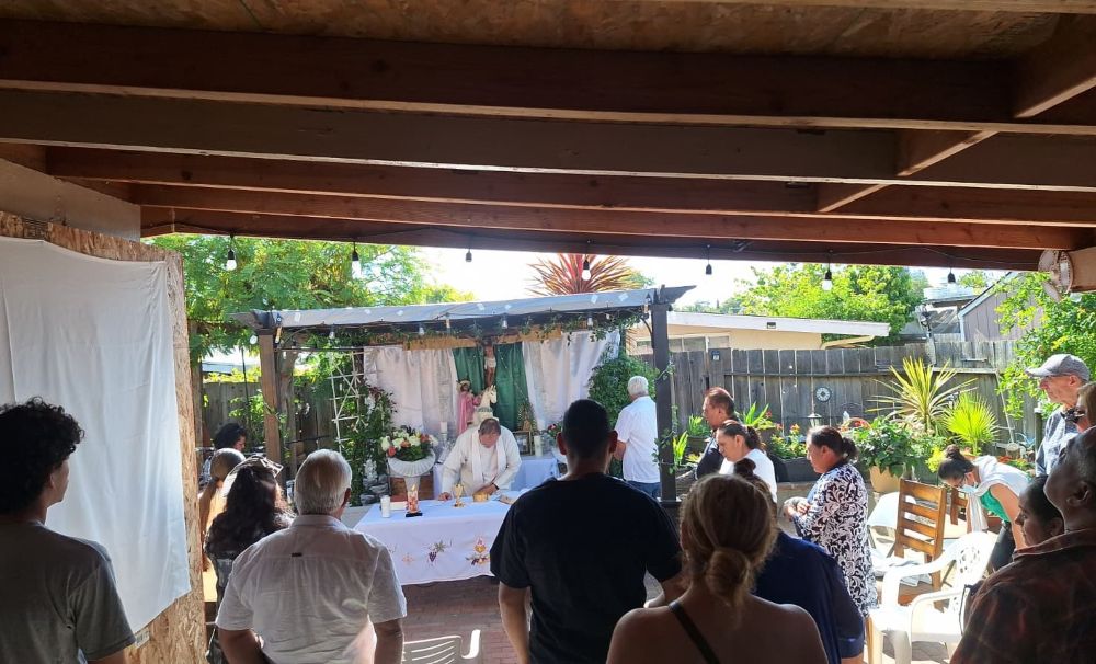 A group participates in a neighborhood Mass, which is held in a low-rise apartment carport in Campbell, California, Aug. 21, 2026. About 40 people attended the monthly service that day. (Marissa Nichols) 