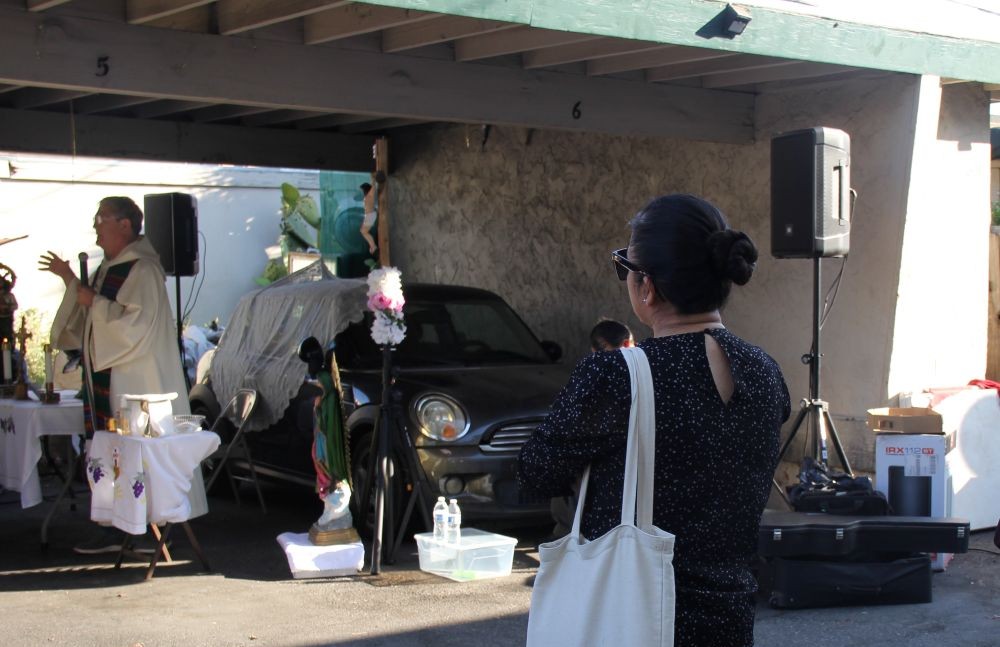 Ivonn Rivera watches Fr. Rick Rodoni celebrate a pop-up Mass Aug. 21, 2026, in Campbell, California. Rivera received the 2023 Cardinal Bernardin New Leadership Award for organizing the "Misas Del Barrio." (Marissa Nichols)
