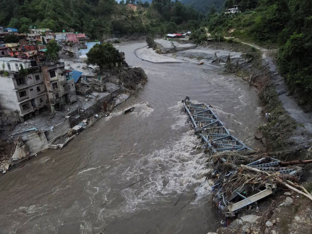 A drone view shows a broken bridge and damaged houses after the flash floods and mudslide, at Devighat, Nuwakot district, Nepal, Aug. 28, 2026. (OSV News/Reuters/Francis Mascarenhas)