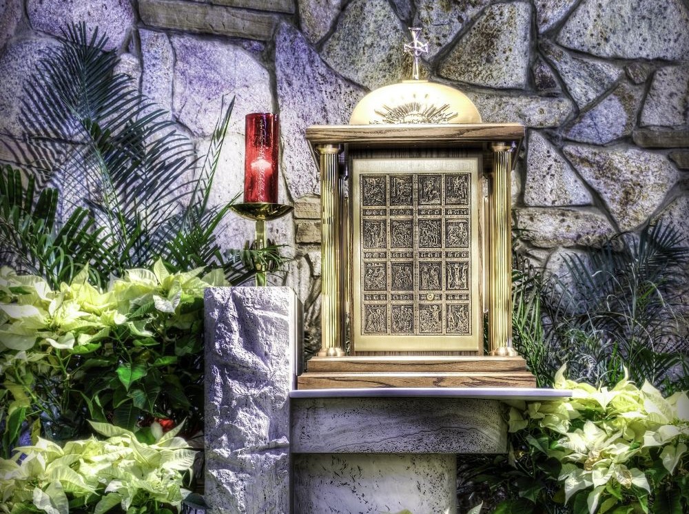 A sanctuary lamp burns beside a tabernacle, indicating that Christ is present in the consecrated hosts within. (OSV News/Pixabay/Vincent Ciro)