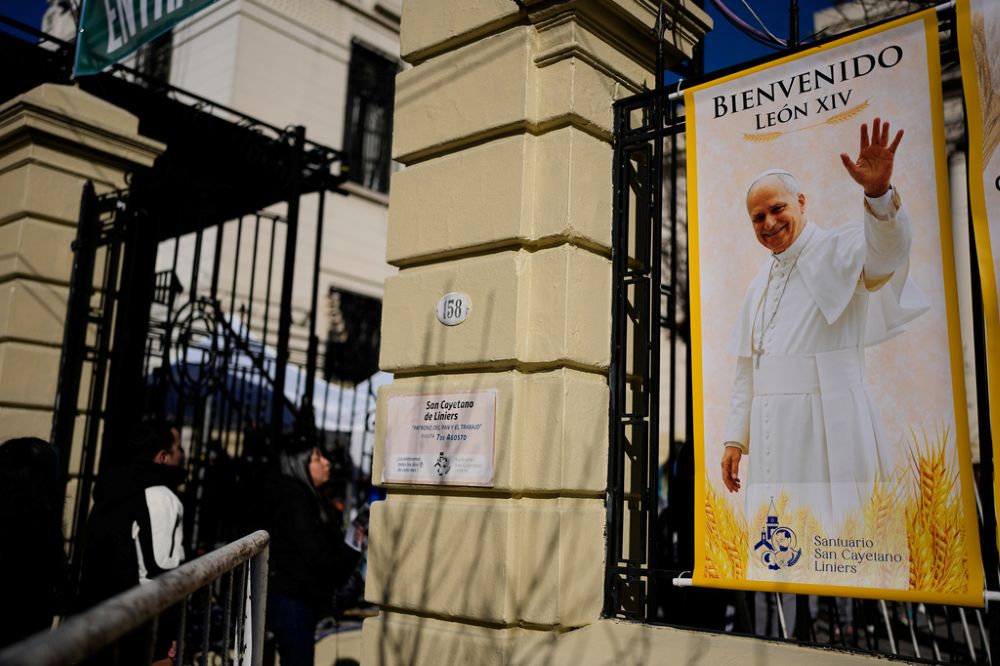 A banner with an image of Pope Leo XIV is posted outside the Church of San Cayetano during the annual pilgrimage honoring St. Cajetan, the patron saint of work, in Buenos Aires, Argentina, Aug. 7, 2026. (AP/Natacha Pisarenko)