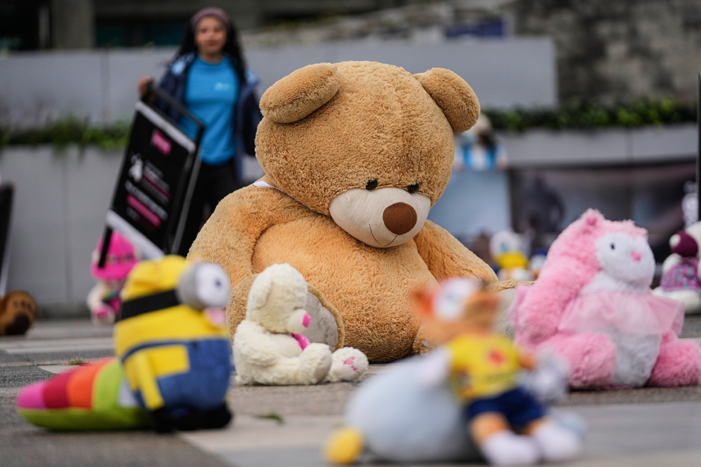 Toys are displayed outside the prosecutor's office in a symbolic act seeking to draw the attention to child sexual abuse in Bogotá, Colombia, Nov. 20, 2025. (AP/Fernando Vergara)