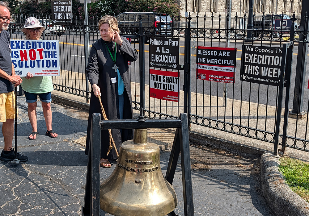 Kristen Hansen, minister of music, rings a bell in opposition to the death penalty outside First Evangelical Lutheran Church, Aug. 13, 2026, in downtown Nashville. (RNS/Courtesy of Death Penalty Action)