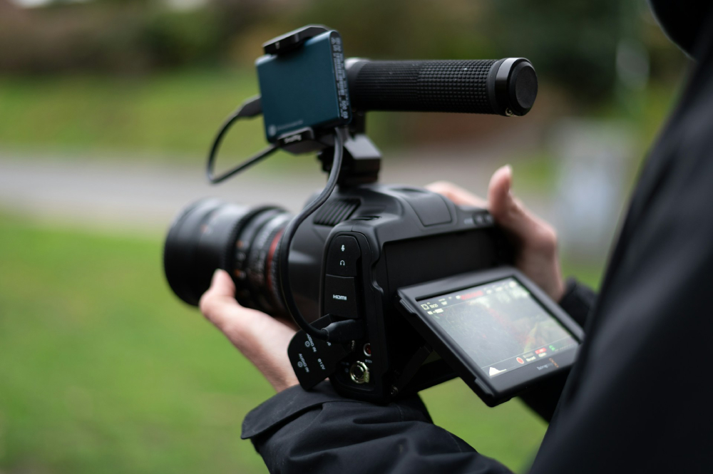 Hands operating a camera.