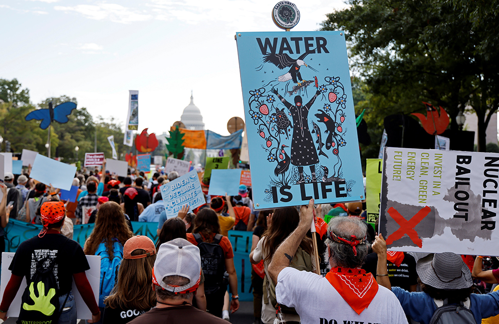 Environmental activists march to the U.S. Capitol during a climate change protest in Washington Oct. 15, 2021. (CNS/Reuters/Jonathan Ernst)