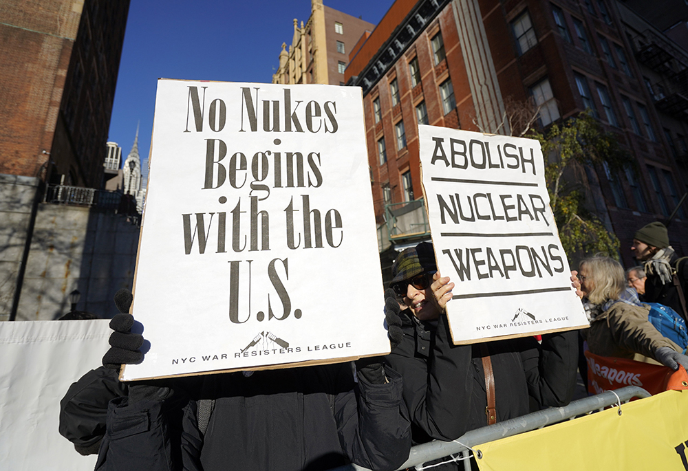 Demonstrators hold signs as they face United Nations headquarters in New York City during a rally to abolish nuclear weapons Nov. 28, 2023. Catholic Worker and Pax Christi members were among the participants. (OSV News/Gregory A. Shemitz)