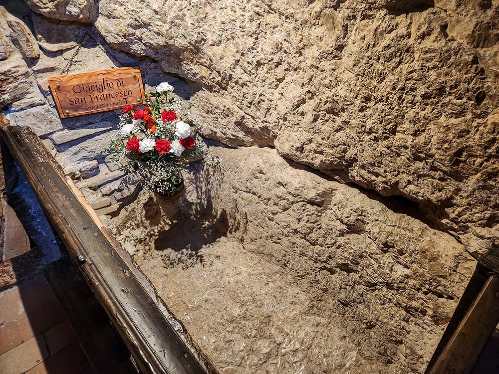 The grotto of St. Francis, where he slept more than eight centuries ago, is enshrined inside Eremo delle Carceri. (NCR photo/Brian Roewe)
