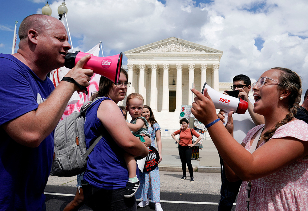 An anti-abortion activist and a supporter of legal abortion square off with megaphones in front of the U.S. Supreme Court in Washington June 24, 2023, the first anniversary the court's 2022 ruling in Dobbs v. Jackson Women's Health Organization. (OSV News/Reuters/Evelyn Hockstein)