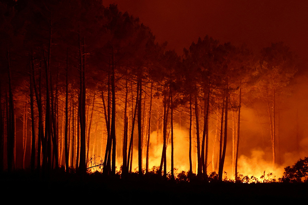 Smoke rises as flames burn during a wildfire in Ares, France, July 25, 2026. (OSV News/Reuters/Stephane Mahe)