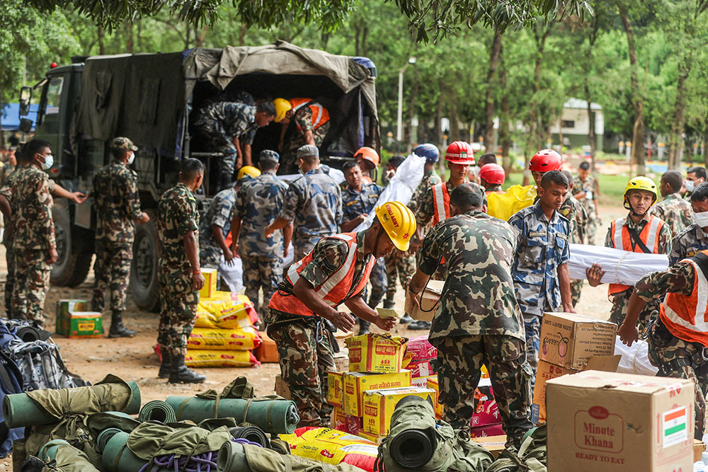Armed Police Force and army personnel unload relief material from a vehicle at the Maithili Barrack Army training center at Trishuli in Nepal's Nuwakot district Aug. 31, 2026, following flash floods and a mudslide. (OSV News/Reuters/Francis Mascarenhas)