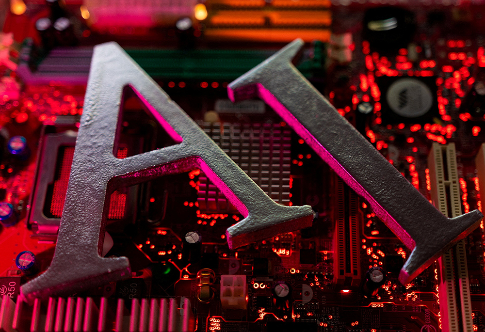 The letters AI (for "artificial intelligence") are placed on a computer motherboard in this illustration taken June 23, 2023. (OSV News/Reuters/Dado Ruvic)
