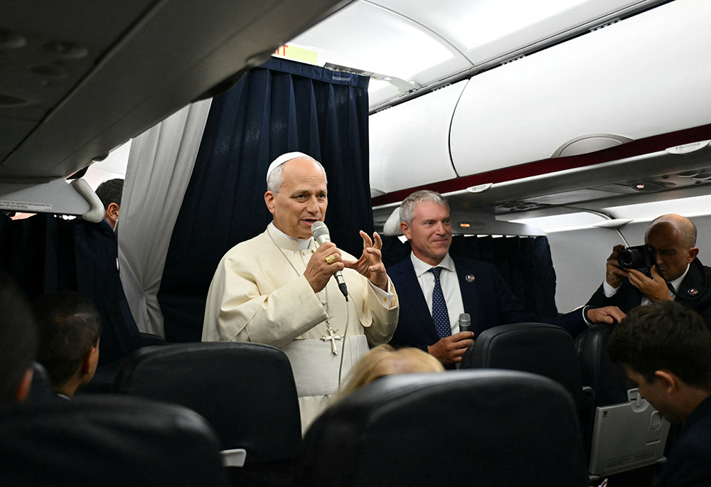 Pope Leo XIV speaks with journalists aboard his flight back to Rome Sept. 28, 2026, after concluding his Sept. 25-28 apostolic journey to France. The pope visited Paris, Saint-Denis, Lourdes and Metz during his trip. (CNS photo/Alberto Pizzoli, pool via Reuters)