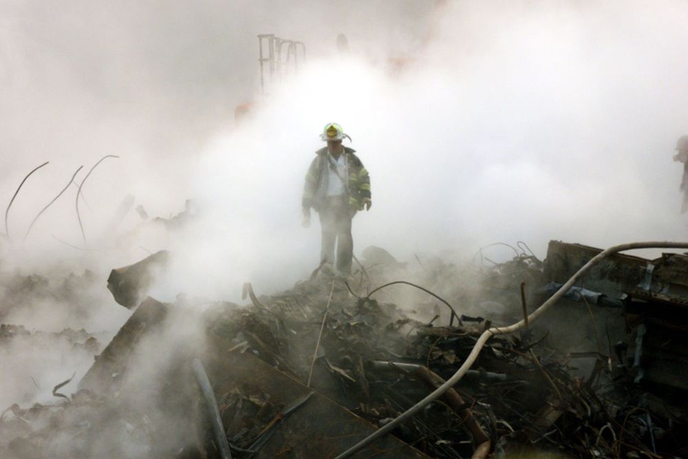 A firefighter walks amongst the rubble and the smoldering wreckage of the World Trade Center Oct. 11, 2001, in New York. (AP/Gary Friedman, pool)
