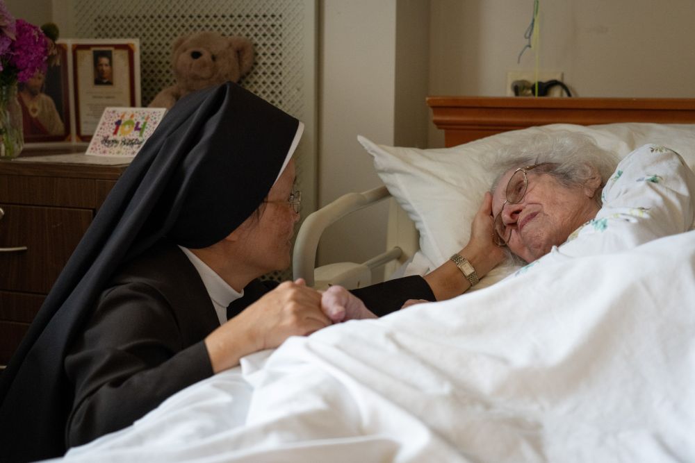 A Carmelite Sister comforts a resident Aug. 21, 2026, at St. Patrick’s Residence in Naperville, Ill. (OSV News/Courtesy Becket)