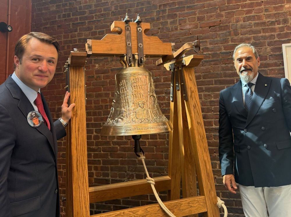 Dominick R. DeRubbio, executive director of the New York City Fire Museum (left), and Pasquale Marinelli, who runs the Marinelli Pontifical Bell Foundry in Agnone, Italy, by the memorial bell after the unveiling ceremony on Sept. 11, 2026. (Courtesy of Rosita Marinelli)