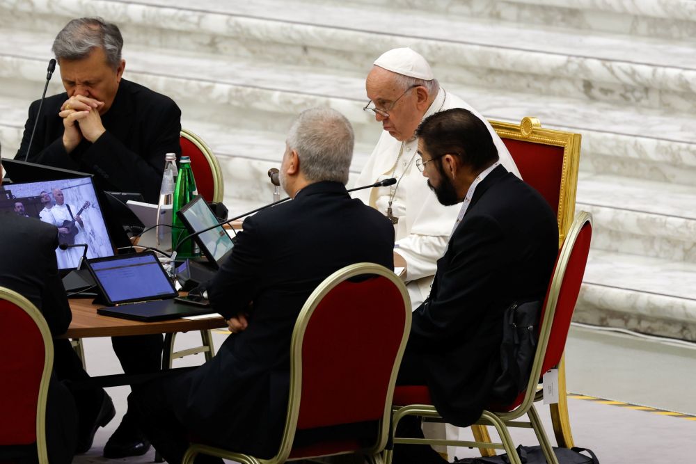 Bishop Daniel Flores of Brownsville, Texas, sits next to Pope Francis for prayers with leaders of the assembly of the Synod of Bishops  before a working session in the Vatican's Paul VI Audience Hall Oct. 20, 2023. (CNS/Lola Gomez)