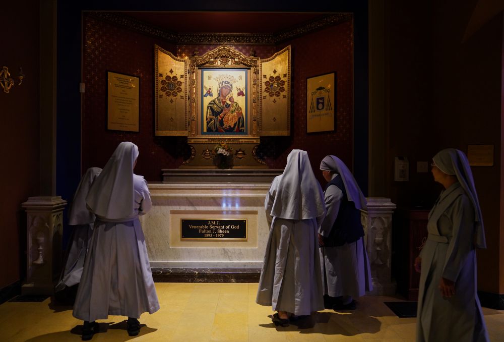 Nuns pray at the tomb of Archbishop Fulton Sheen at the Cathedral of St. Mary of the Immaculate Conception in Peoria, Ill., on July 15, 2026. Sheen is to be beatified Sept. 24 in St. Louis. (AP/Jessie Wardarski)